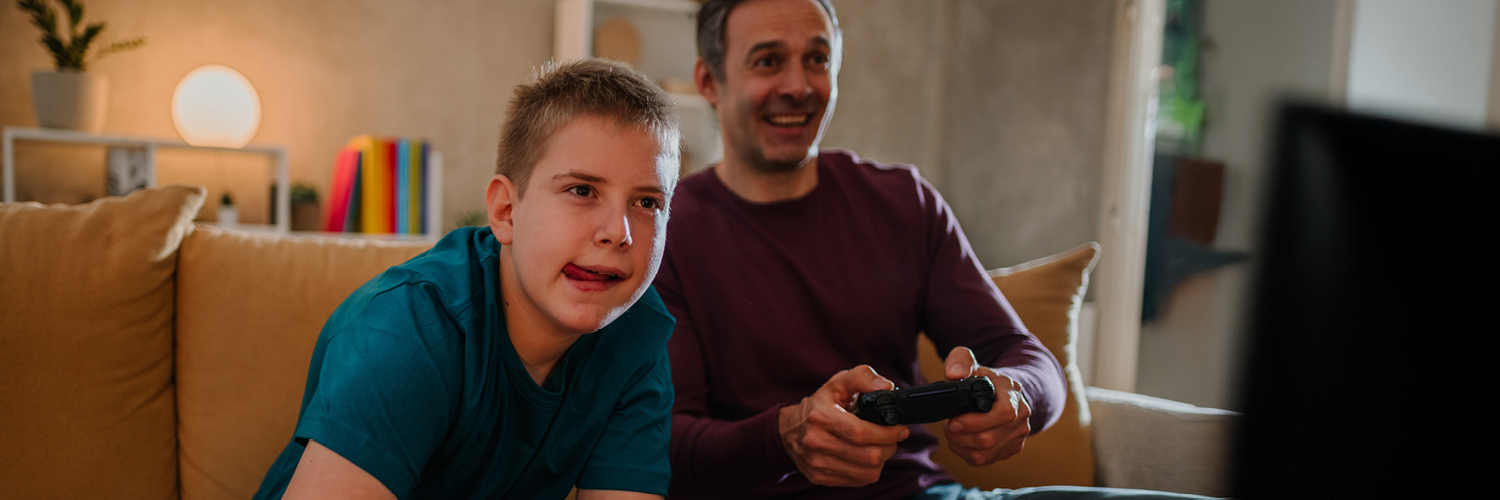 Foster child and foster parent playing computer games